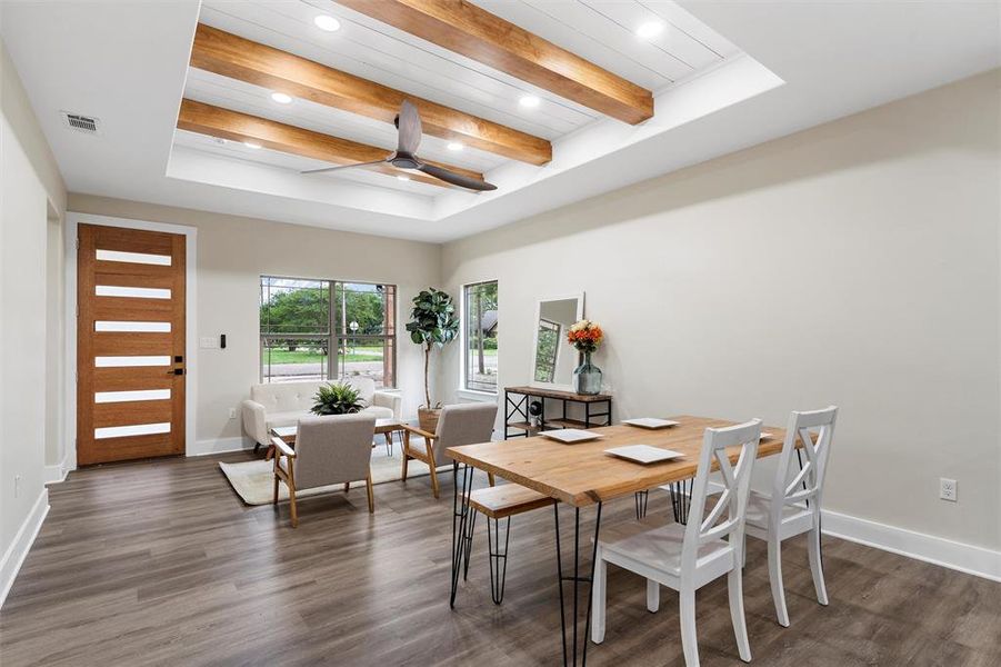 Dining room featuring recessed lighting, dark wood finished floors, baseboards, a raised ceiling, and a ceiling fan