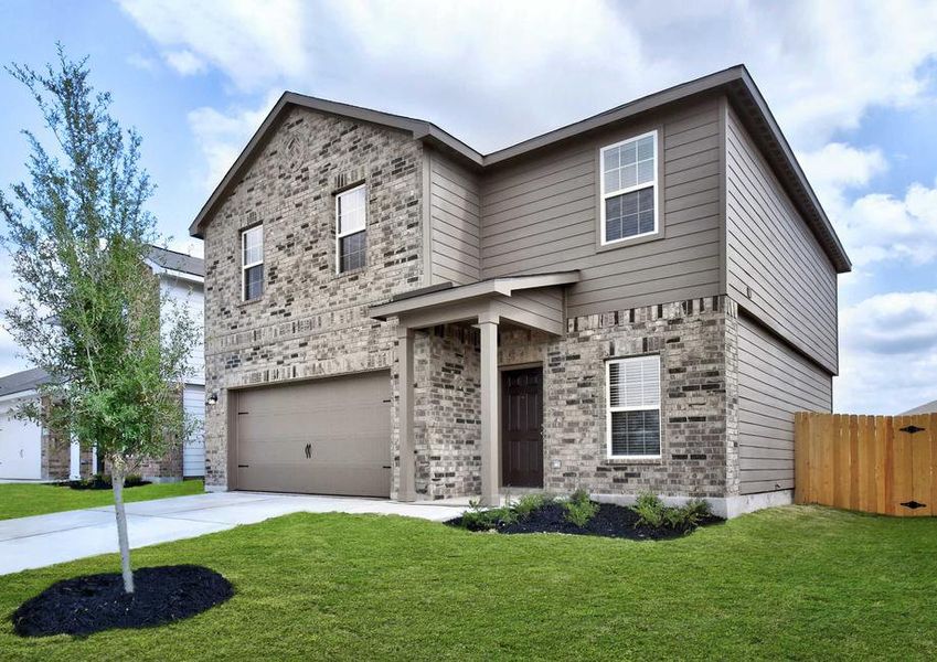 Rio new home completed with light brick siding, green grass and tree landscaped yard, and two living levels