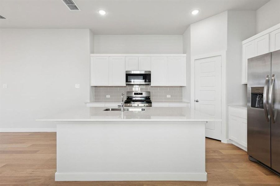 Kitchen in the Cedar home plan by Trophy Signature Homes – REPRESENTATIVE PHOTO