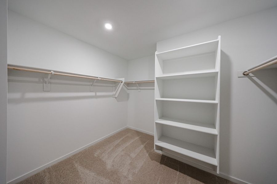 A white shelf in a room. A white shelf in a room.