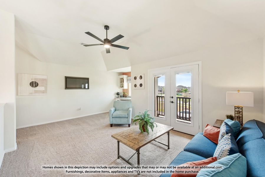 Living room with vaulted ceiling, ceiling fan, carpet flooring, and French doors leading to a balcony
