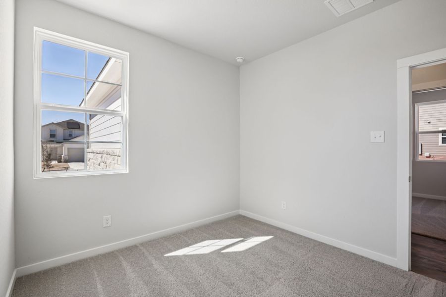 A room with a window and a carpet. A room with a window and a carpet.