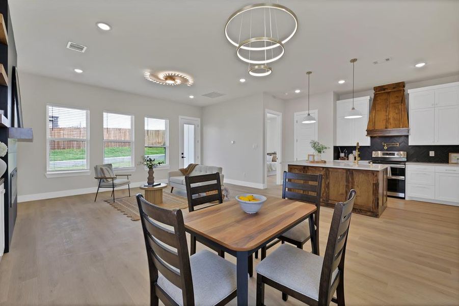 Dining space with baseboards, light wood finished floors, and recessed lighting Dining space with baseboards, light wood finished floors, and recessed lighting