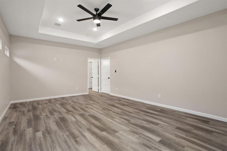 A second view of the primary bedroom into the en suite bathroom