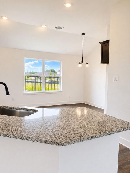 Bright open kitchen with sleek granite countertops, modern finishes, ample cabinet space, and seamless flow into the dining and living areas. Bright open kitchen with sleek granite countertops, modern finishes, ample cabinet space, and seamless flow into the dining and living areas.