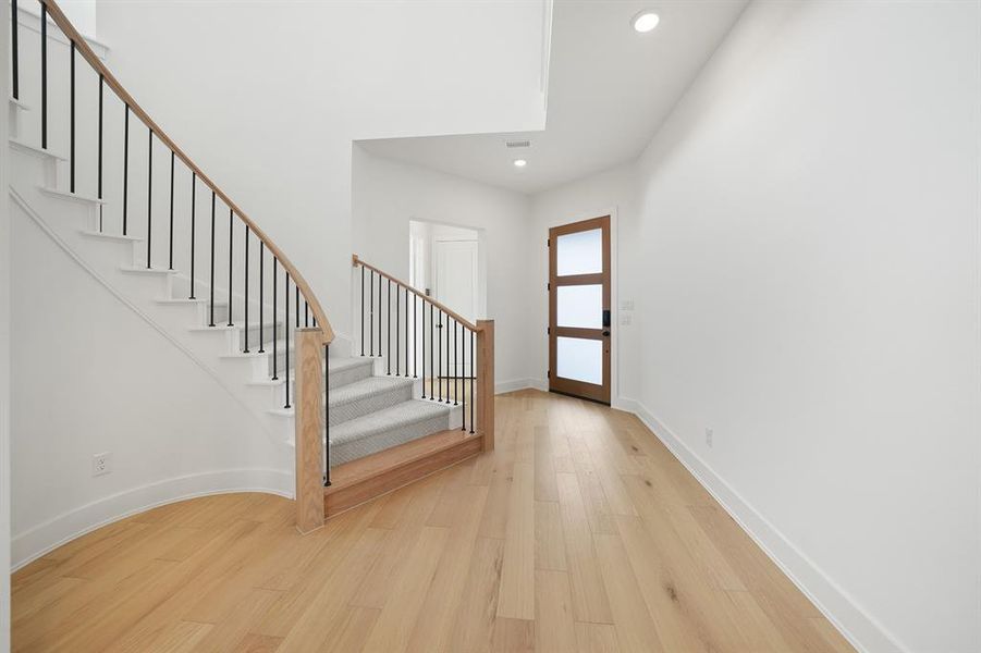 Entrance foyer featuring light wood finished floors, stairs, and recessed lighting