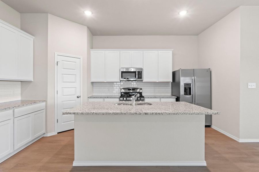 The center island comes with a built-in breakfast counter, creating the perfect spot for quick morning meals or chatting while dinner is cooking The center island comes with a built-in breakfast counter, creating the perfect spot for quick morning meals or chatting while dinner is cooking
