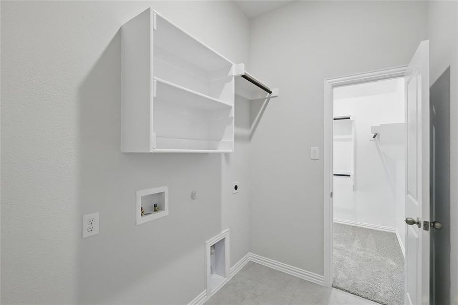 Laundry area with gas dryer hookup, electric dryer hookup, and washer hookup Laundry area with gas dryer hookup, electric dryer hookup, and washer hookup