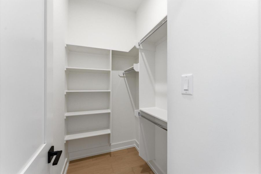 Walk-in closet for secondary bedroom.