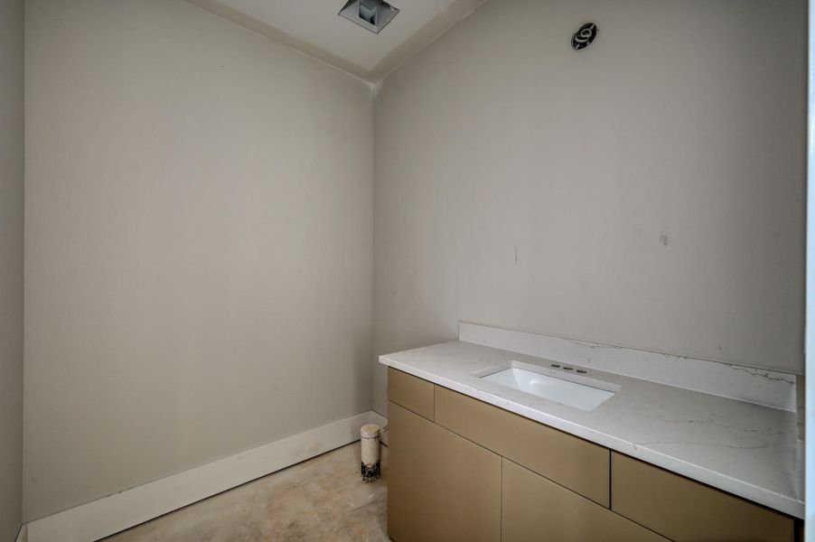 The half bath located near the living and kitchen area.
