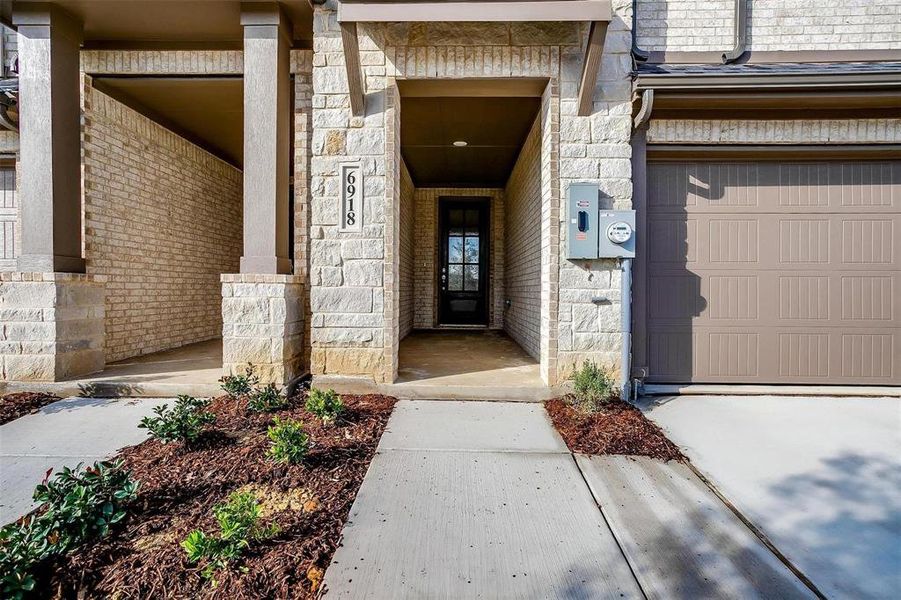 Doorway to property featuring stone siding and driveway Doorway to property featuring stone siding and driveway