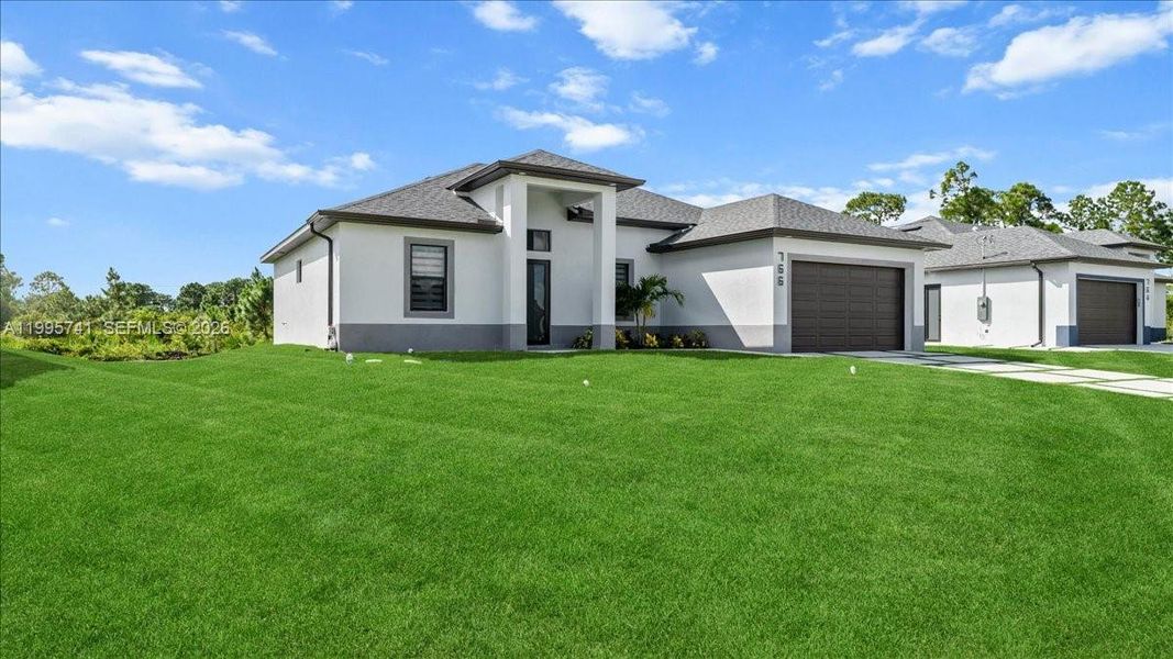 Front exterior of a new home in , Lehigh Acres, FL, highlighting curb appeal (Image 23). Front exterior of a new home in , Lehigh Acres, FL, highlighting curb appeal (Image 23).
