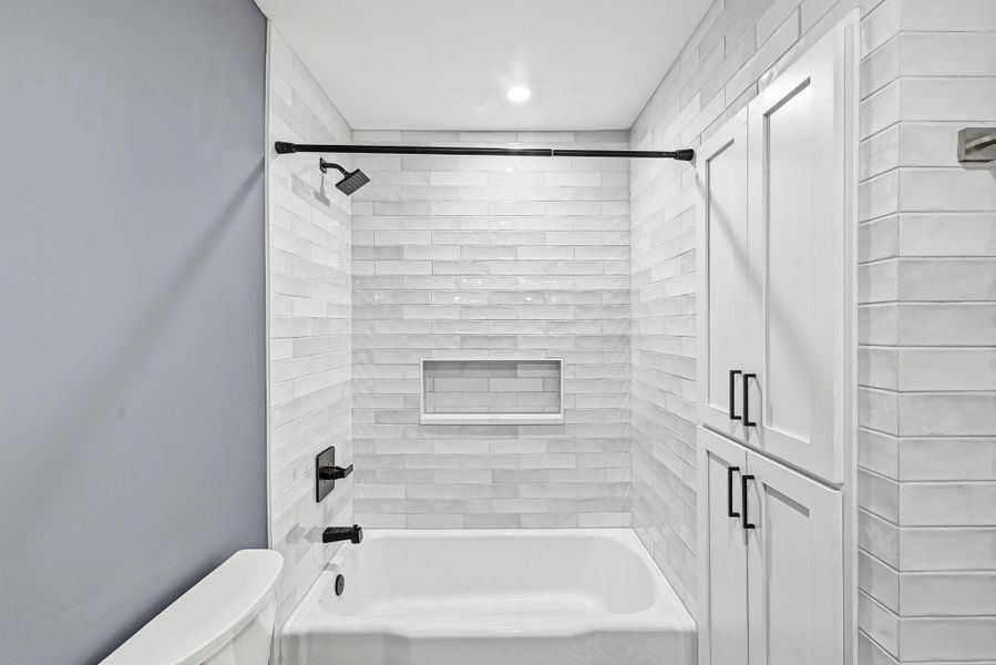 Full bath with toilet and tub / shower combination