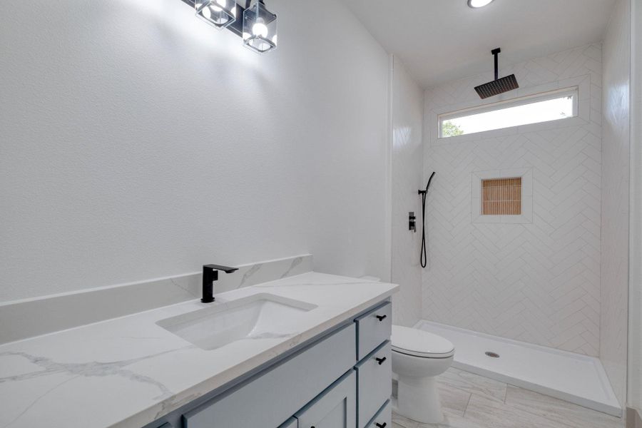 Bathroom with vanity and a stall shower Bathroom with vanity and a stall shower