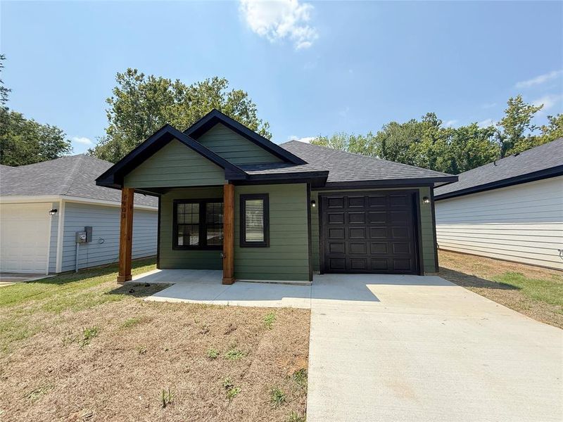 Front exterior of a new home in , Denison, TX, highlighting curb appeal (Image 2).