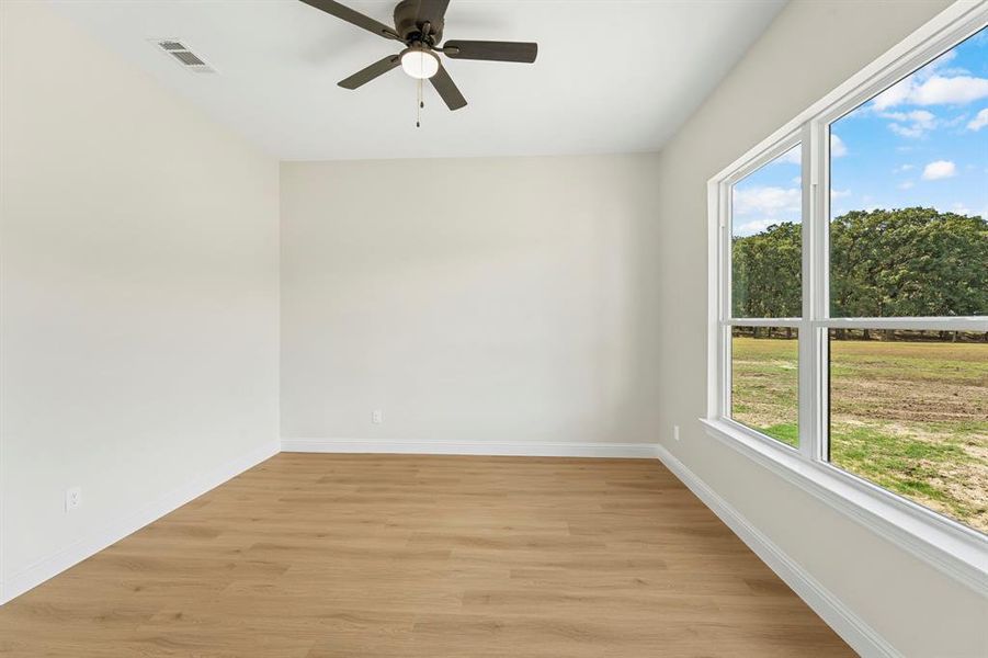 Unfurnished room with light wood-style flooring and ceiling fan