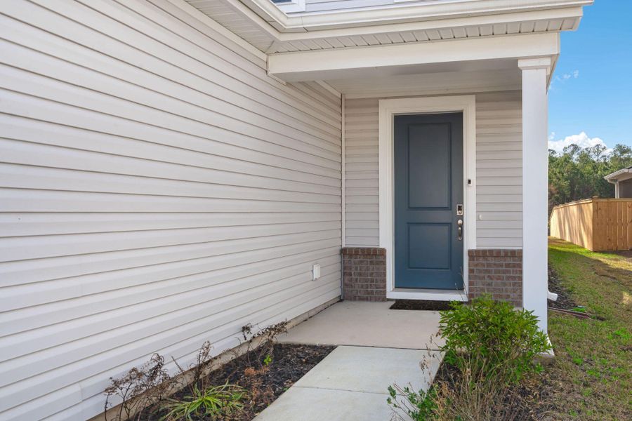 Exterior details and patio area of a home in Jasmine Point at Lakes of Cane Bay, Summerville (Image 3).
