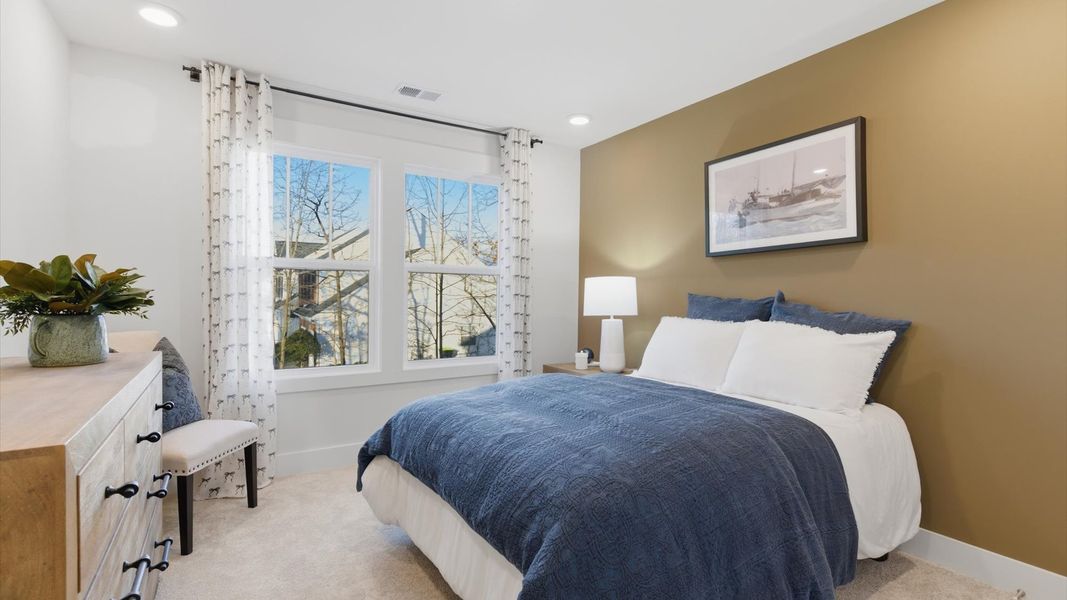 Vibrant and restful bedroom with oversized windows, refined detail, and a warm, welcoming atmosphere at Pelham Crossing