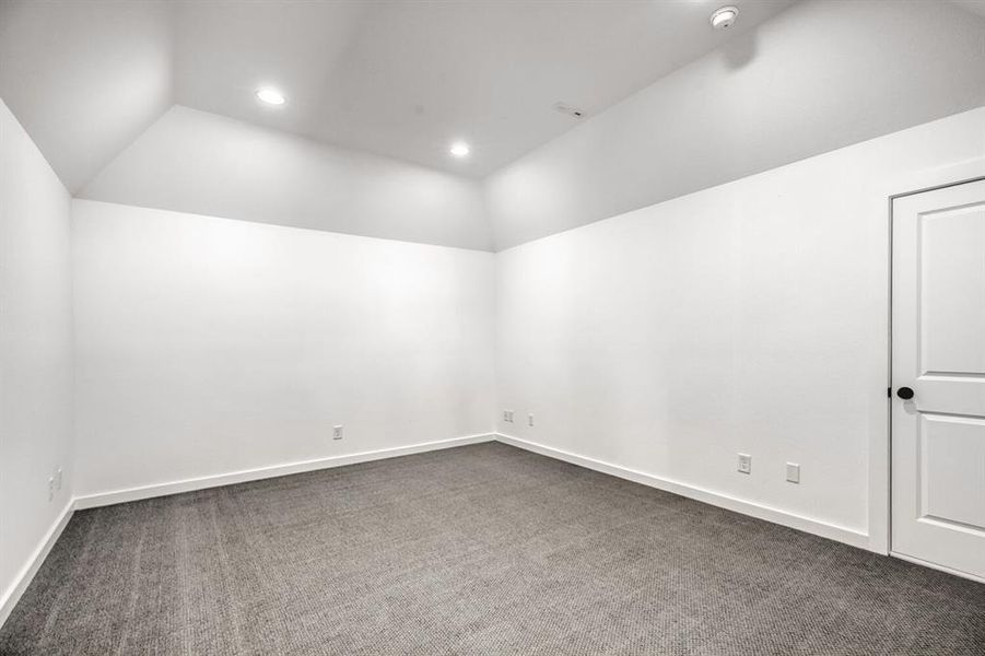 Unfurnished room featuring lofted ceiling, carpet floors, and recessed lighting