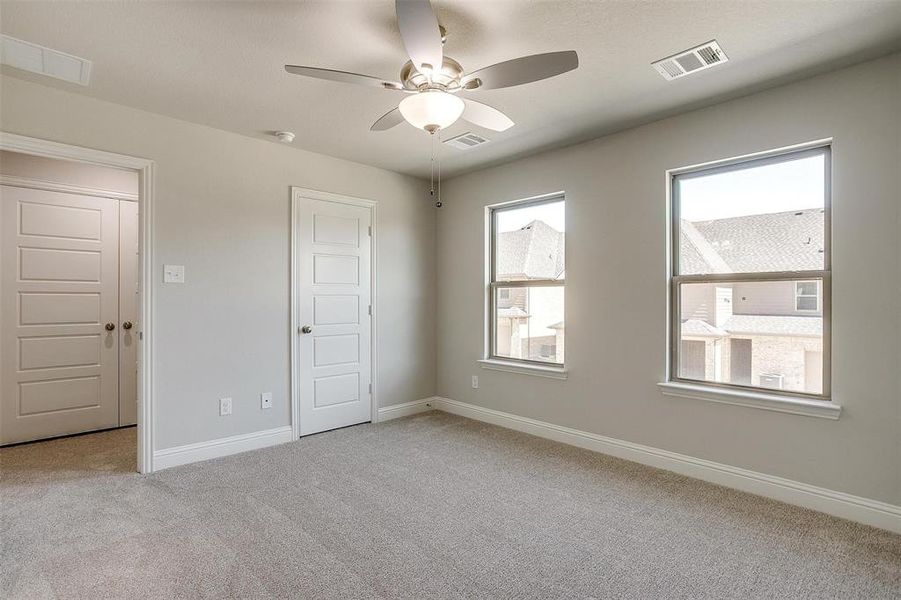 Spare room with ceiling fan and light carpet