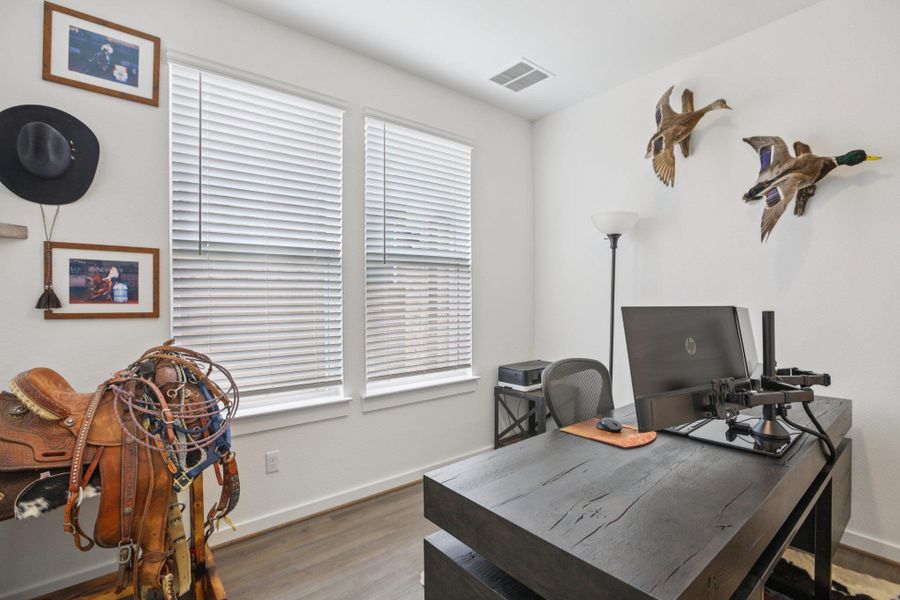 Office space featuring wood finished floors and baseboards Office space featuring wood finished floors and baseboards