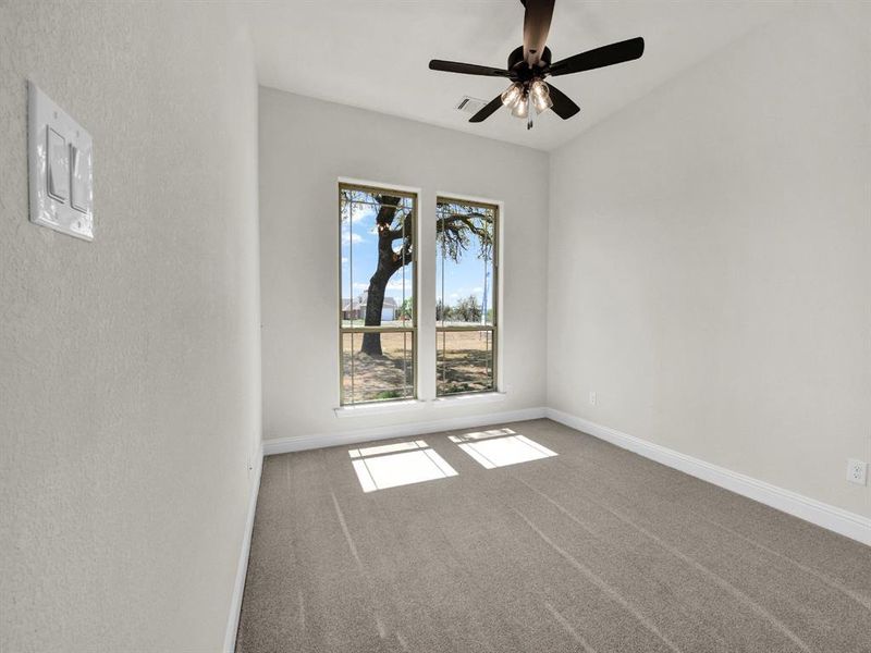 Unfurnished room featuring baseboards, visible vents, ceiling fan, and carpet flooring Unfurnished room featuring baseboards, visible vents, ceiling fan, and carpet flooring