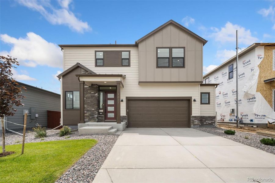 Front exterior of a new home in Festival at RainDance, Windsor, CO, highlighting curb appeal (Image 1).
