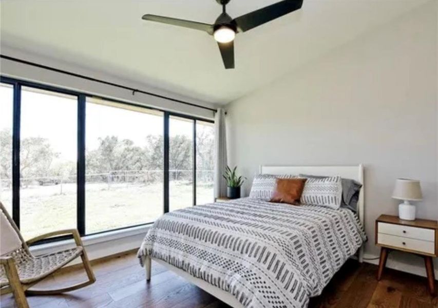 Bedroom with dark wood-type flooring and a ceiling fan Bedroom with dark wood-type flooring and a ceiling fan