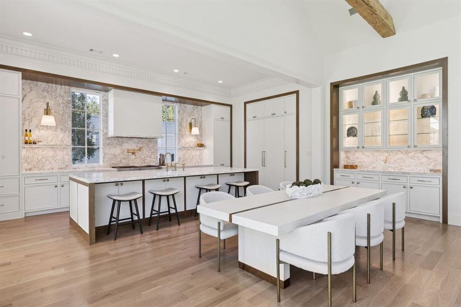 Dining space with light wood finished floors, lofted ceiling, and recessed lighting