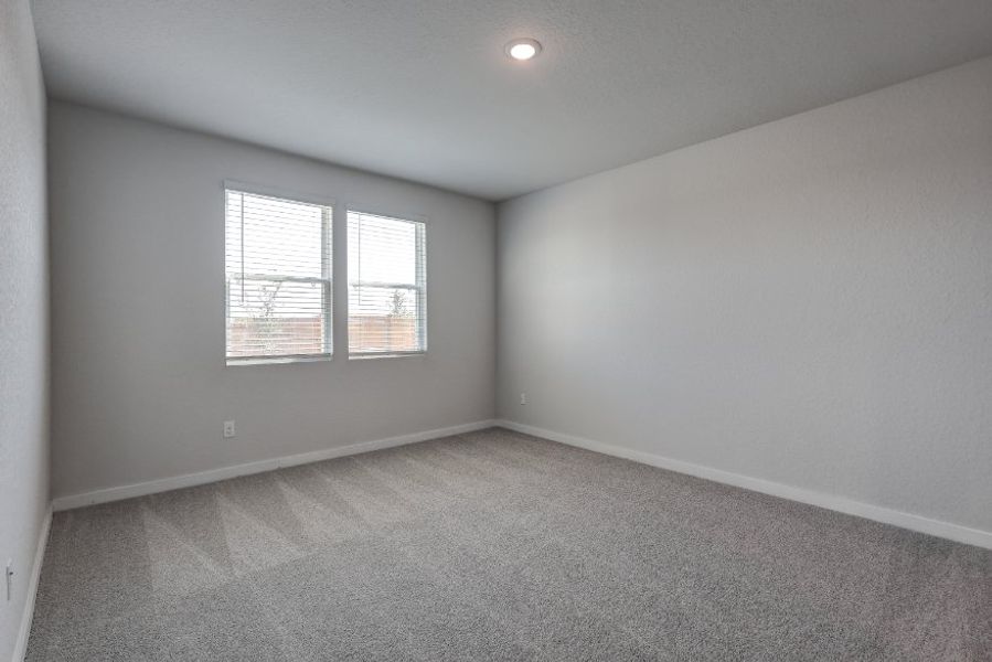 A room with a window and a carpet.