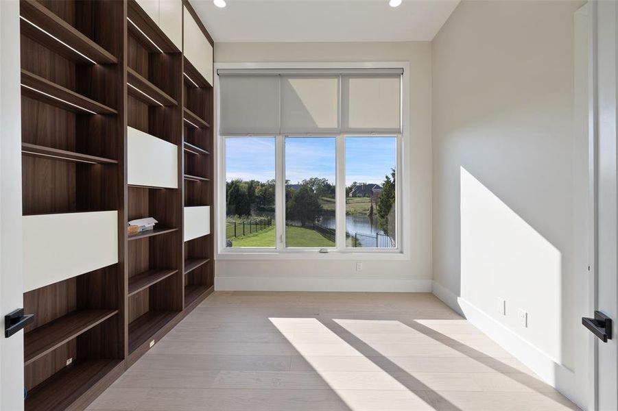 Unfurnished room featuring a water view and hardwood / wood-style floors