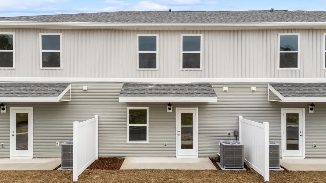 Exterior details and patio area of a home in Genoa Landing Townhomes, Freeport (Image 3).