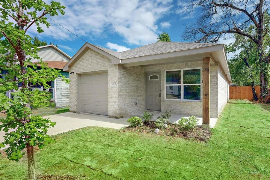 Ranch-style house with a front lawn and a garage