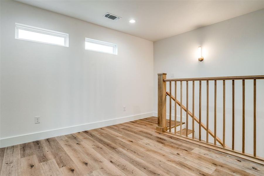 Basement featuring light hardwood / wood-style floors