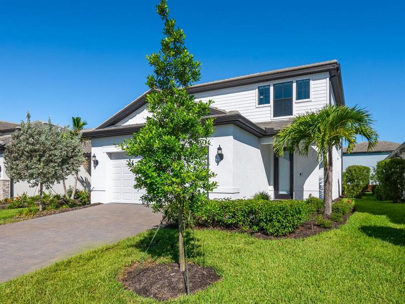 Front exterior of a new home in , Lakewood Ranch, FL, highlighting curb appeal (Image 24).
