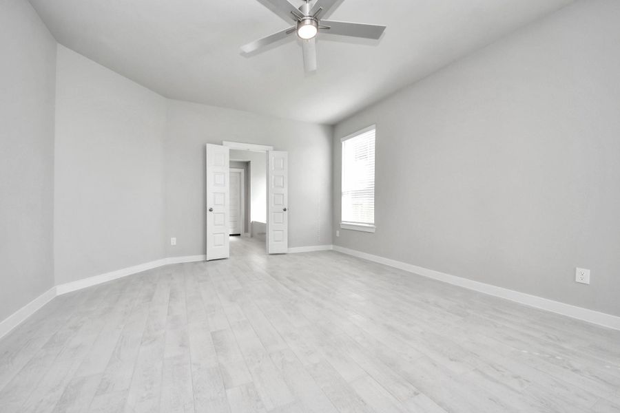 Another perspective unveils a comprehensive view of the serenity and comfort this primary suite offers. Sample photo of completed home with similar floor plan. Actual colors and selections may vary.