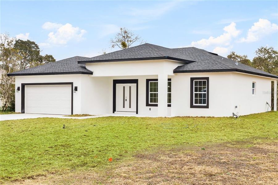 Front exterior of a new home in , Citrus Springs, FL, highlighting curb appeal (Image 24).