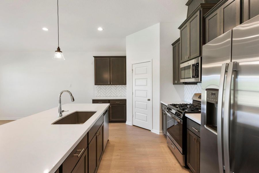 Enjoy ample countertop space with sleek quartz surfaces, perfect for meal prep and gatherings.