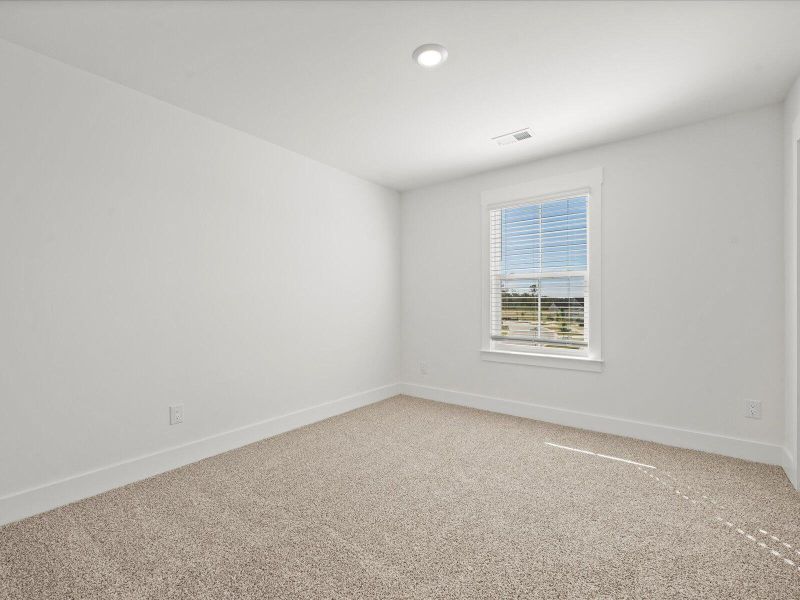 Spacious, unfurnished interior of a new home in The Coves at Lakes of Cane Bay, Summerville (Image 19).