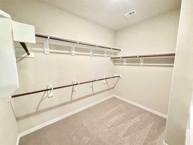 Walk in closet featuring light colored carpet Walk in closet featuring light colored carpet