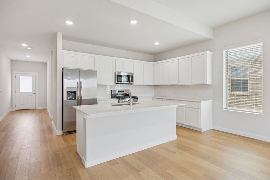 Kitchen in the Stanley II home plan by Trophy Signature Homes – REPRESENTATIVE PHOTO