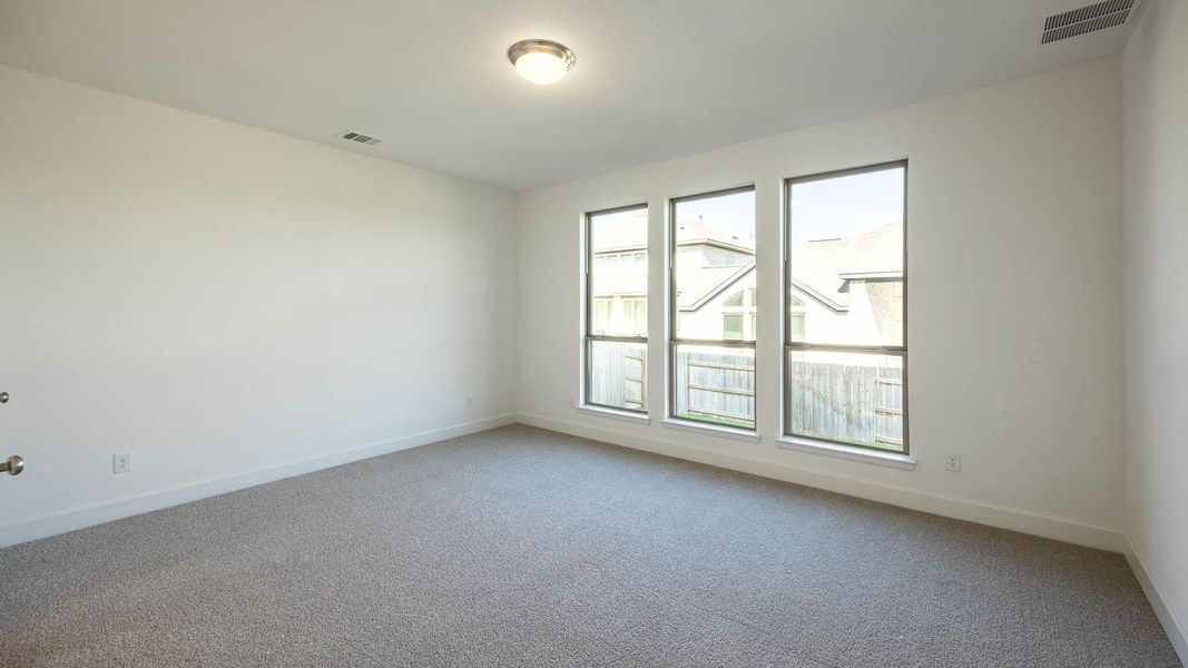 Carpeted spare room with baseboards