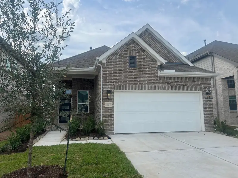 Front exterior of a new home in Wood Leaf Reserve, Tomball, TX, highlighting curb appeal (Image 1).