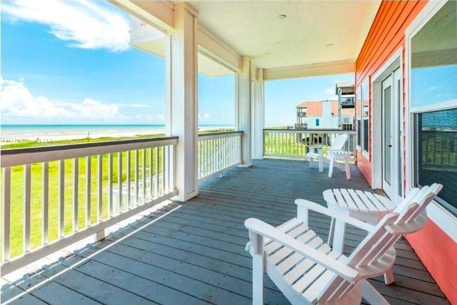 Enjoy panoramic beachfront views from the covered deck