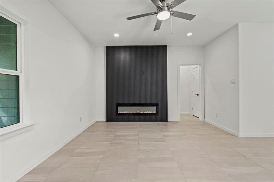 Unfurnished living room with recessed lighting, a large fireplace, ceiling fan, and light tile patterned floors