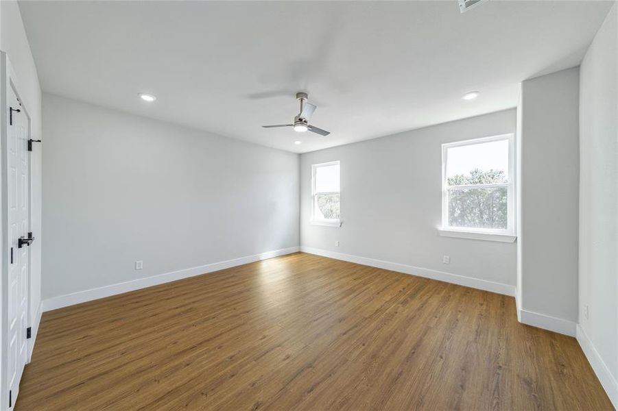 Unfurnished room with wood finished floors, recessed lighting, and ceiling fan Unfurnished room with wood finished floors, recessed lighting, and ceiling fan