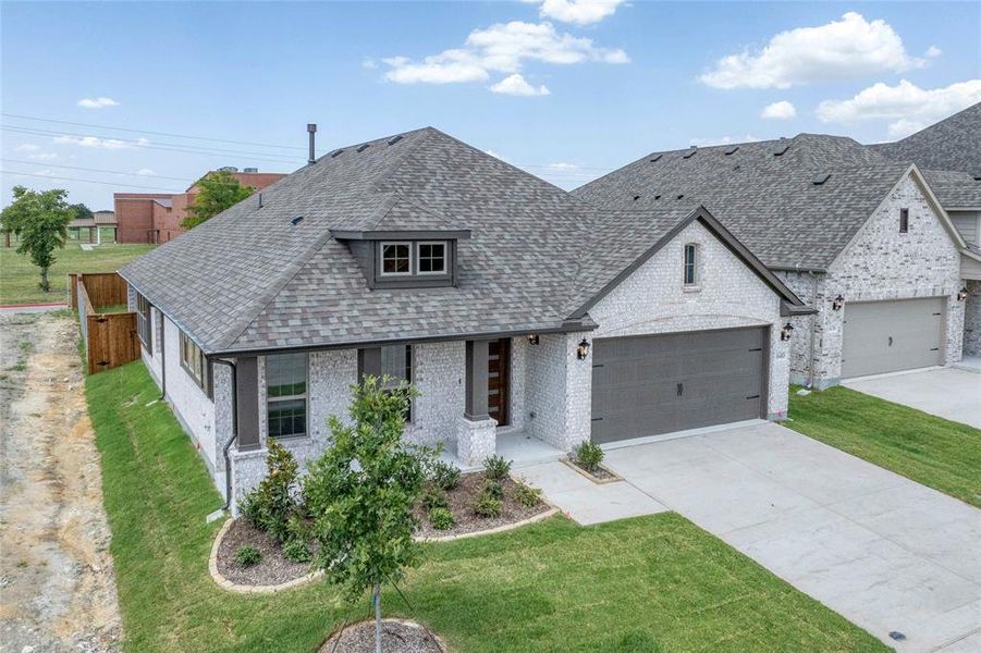 View of front of property with brick siding, a front lawn, roof with shingles, and concrete driveway View of front of property with brick siding, a front lawn, roof with shingles, and concrete driveway