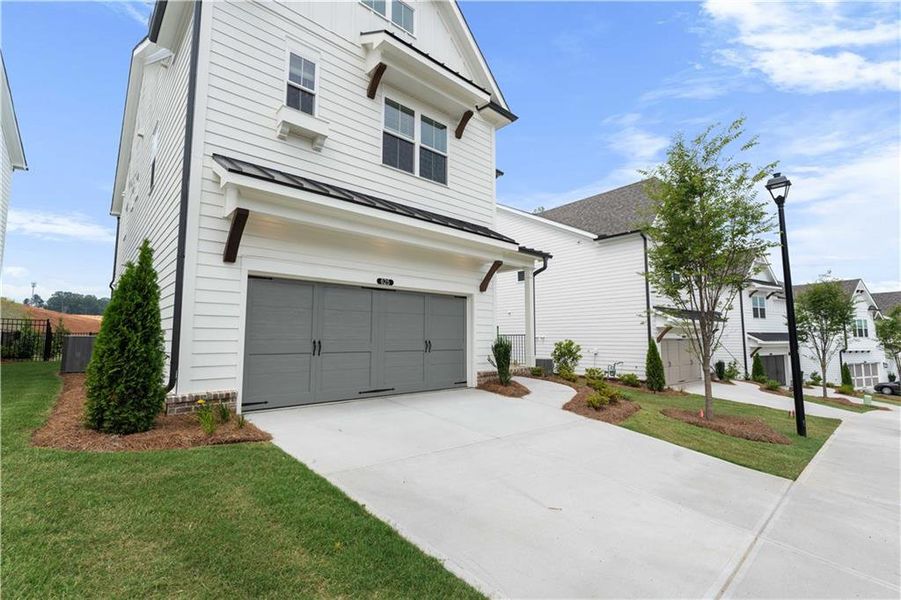 Front exterior of a new home in Palisades Single Family, Cumming, GA, highlighting curb appeal (Image 37).