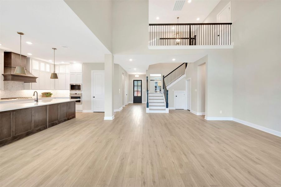 Open yet great definition to the rooms.  A stairway that turns makes it not only safer but gives a classy look to the room!
