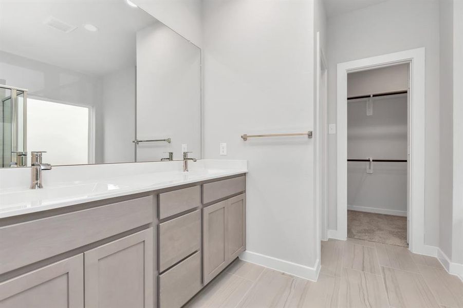 Indulge in a spa-like retreat within the confines of this primary bathroom. Sample photo of completed home with similar floor plan. As-built interior colors and selections may vary.